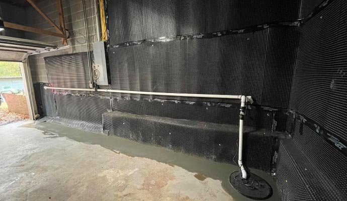 Basement waterproofing system with a sump pump
