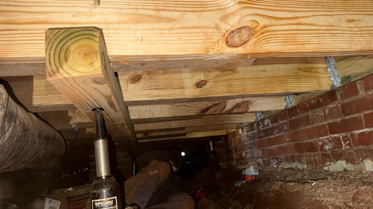 New pressure-treated band sill and support post installed in a Charlotte crawl space