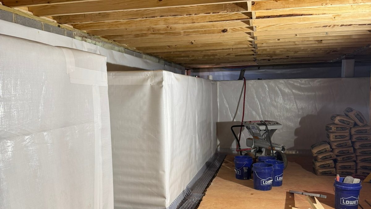 Interior drainage and wall vapor barrier installed in a basement