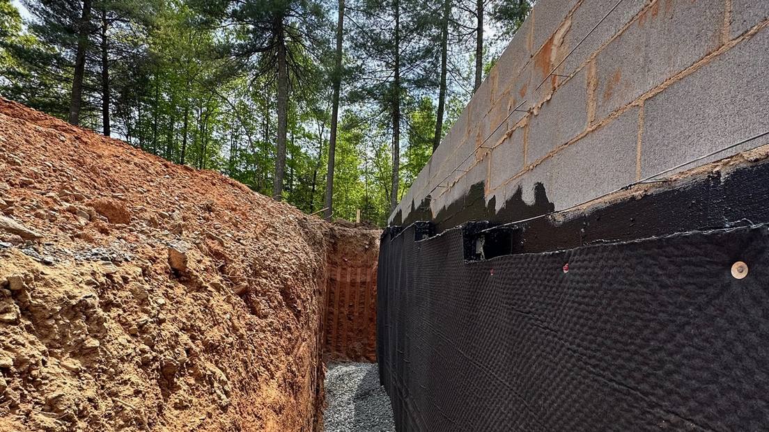Exterior foundation waterproofing membrane and gravel drainage