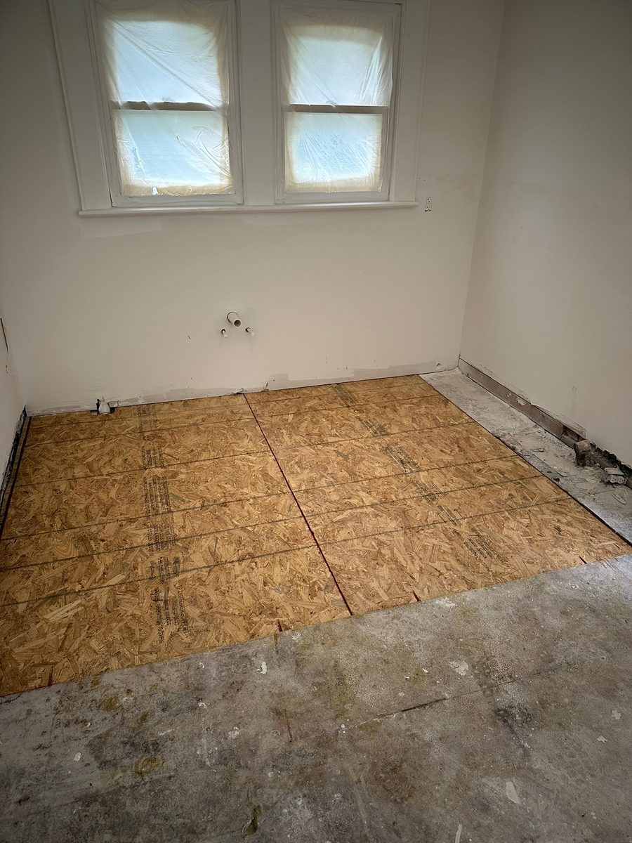 New subfloor decking laid over repaired framing in a Charlotte crawl space