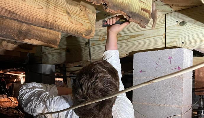 Person repairing crawl space 