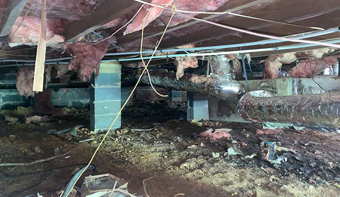 Messy crawl space with sagging floor