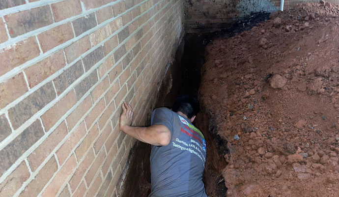 A professional repairing damaged foundation