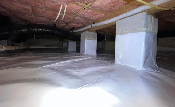clean and dry crawl space with white covering on the floor