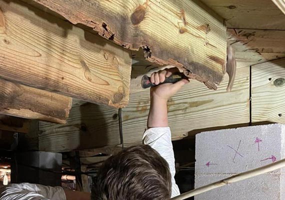 Professional worker repairing band sill